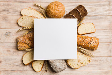 Minimalist paper blank mockup on background of Types of homemade bread. Different kinds of fresh...