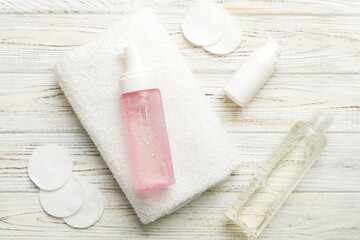 Micellar cleansing water and discs to remove cosmetics and cleanse the skin on colored background. Copy space top view