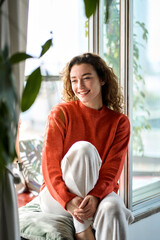 Smiling calm lady chilling in apartment, dreaming, thinking of peaceful time enjoying peace of...