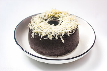chocolate cake with cheese sprinkles in a plate isolated on white background