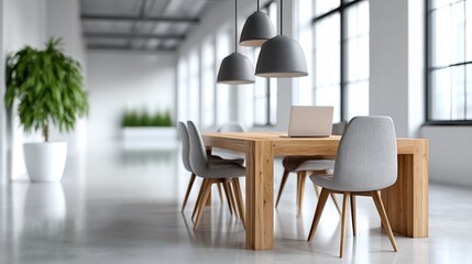 Fototapeta premium Modern office space with a wooden table and four chairs. A laptop is on the table. The room is well lit and has a clean, minimalist look
