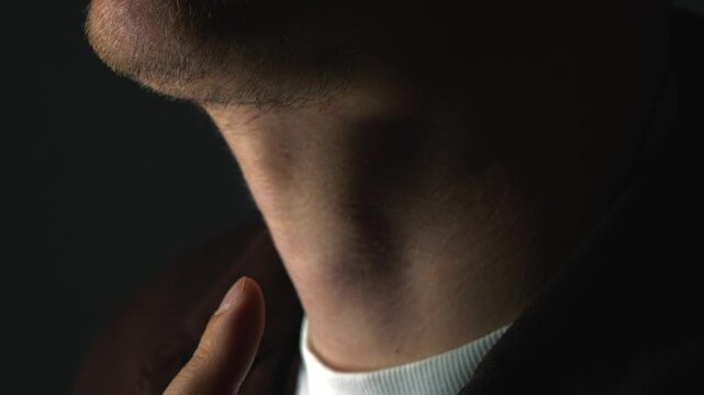 Close-up of a man's Adam's apple.
The man swallows.
A man's throat and Adam's apple during swallowing.
Adam's apple, swallow, throat, body, beard