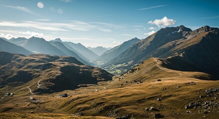 a view of a mountain valley with a road winding through it