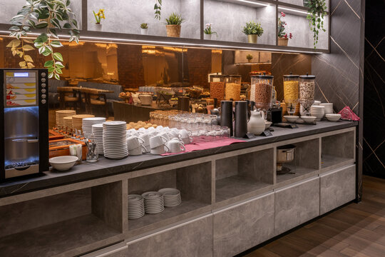Buffet table with coffee, juices, and cereals for breakfast