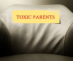 Armchair with label written Toxic Parents - Unhealthy relationships with emotionally abusive parents - emotional harm or mistreatment that make child undermines their self-worth