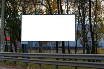 Advertising billboard along the road in the city on a autumn sunny evening. Background for design. 