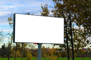 Advertising billboard along the road in the city on a autumn sunny evening. Background for design. 