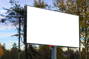 Advertising billboard along the road in the city on a autumn sunny evening. Background for design. 