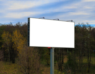 Advertising billboard along the road in the city on a autumn sunny evening. Background for design. 