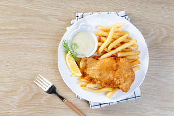 Fish and Chips: Classic British meal of crispy battered fish served with golden fries and tartar...
