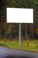 Fototapeta premium White billboard along the highway. Background for design and advertising.