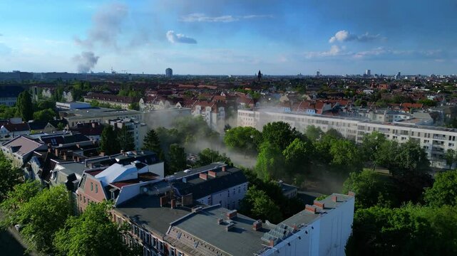 Yellow rescue helicopter landing in a Berlin urban park during a dust emergency. Best aerial view flight drone shot footage from above drone
