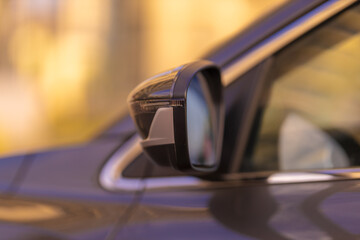 The sun is reflected in the mirror, evening road. View in the rear view side mirror of a auto,...