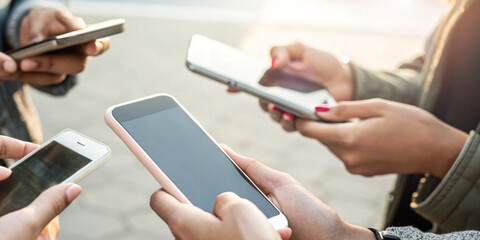Hand of a person holding a smartphone in the concept of mobile internet communication with real time updates of news and information