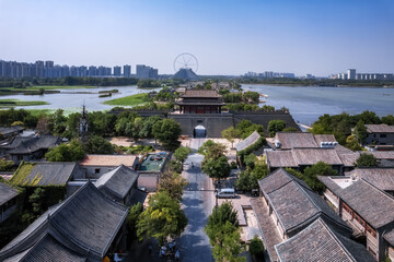 Naklejka premium Panoramic View of a Chinese Town with Ancient Walls and Modern Cityscape