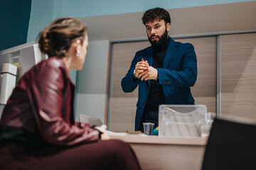 Professional coworkers engaging in a focused conversation, exchanging ideas during a discussion in...