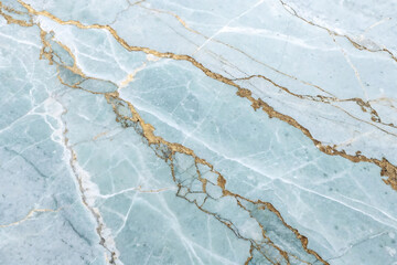Elegant light blue marble texture with golden veins background