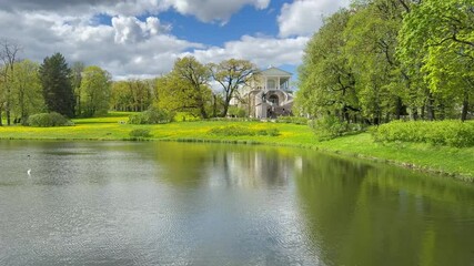 Saint Petersburg. Pushkin. Tsarskoe Selo. Video of the Big Pond and the building of the historical royal pavilion Cameron Gallery of 1785 in Catherine Park on a sunny spring day
