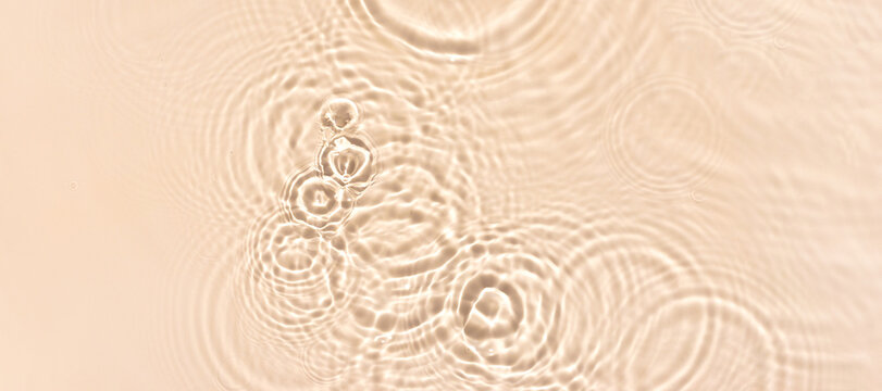 water texture ripples wave clean transparent water abstract background in beige color