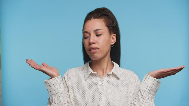 Woman weighing options with unsure expression on blue
