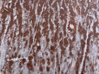 weathered brown metal surface with white mineral streaks and scratch textures, ideal for grunge design, background texture, digital artwork, or industrial branding


