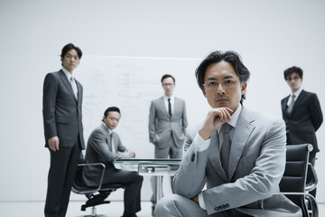 a group of East Asian business professionals in a sleek