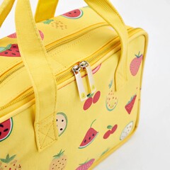 Close-up of a bright yellow kids’ lunch bag with a fun fruit pattern, focusing on the handle and zipper area, on a white background