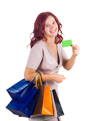 Joyful young woman showing discount card for sale season, carrying shopping bags and smile to camera isolated on transparent background with copy space