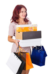Beautiful young woman carrying joyful her shopping bags and boxes isolated on transparent background with copy space