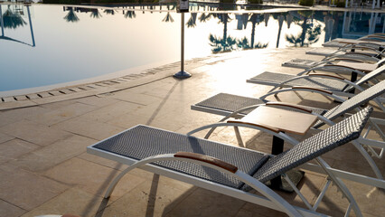 sun beds by the pool near the sea