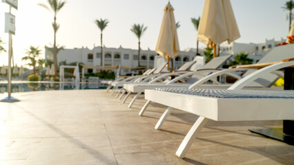 sun beds by the pool near the sea