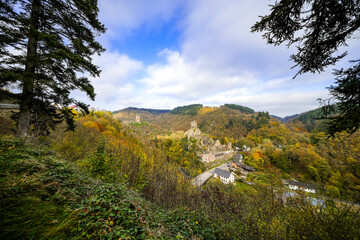 View of the autumn landscape and the Manderscheid Castles near the Eifel town of Manderscheid. Two castle ruins in the forest.