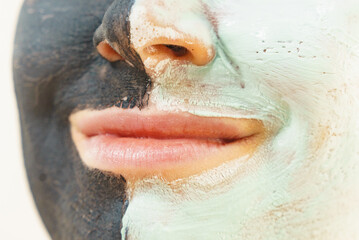 Girl black and green mud mask on face