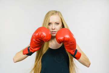 Woman in gloves playing sports boxing