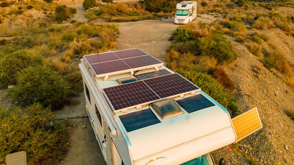 Caravan with solar panels on roof on sea, Spain. Aerial view.