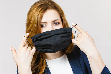 Female using protective face mask.
