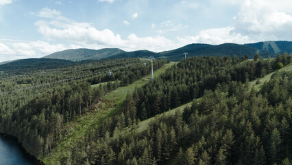 Zlatibor Grand Gondola lift crossing over lush green hills and forests in springtime. Tornik mount in spring time © Ekaterina