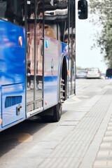 Blue bus for public transportation on city streets.
