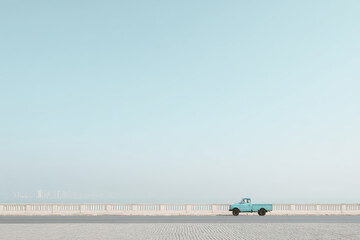 Obraz premium minimalist scene of solitary turquoise vehicle on edge of urban highway in brazil at high noon