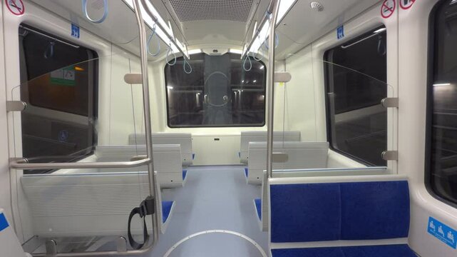 An empty driverless subway train showcases modern seating and spacious interior design in the late night hours, highlighting a quiet atmosphere.