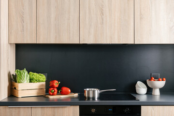Modern kitchen interior with fresh vegetables and stylish decor elements
