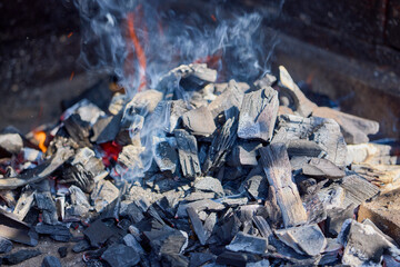 hot coals of a lit grill, ready for the barbecue