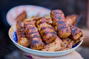 a plate of grilled ( mici ) meatballs, traditional Romanian food