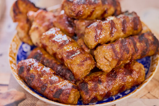 a plate of grilled ( mici ) meatballs, traditional Romanian food