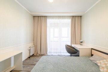 cozy bedroom with a bed, desk, curtains, and soft lighting. The room has a simple, calming aesthetic