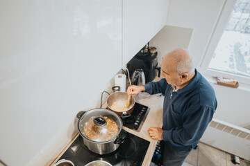Elderly man preparing a meal in a bright home kitchen during daytime
