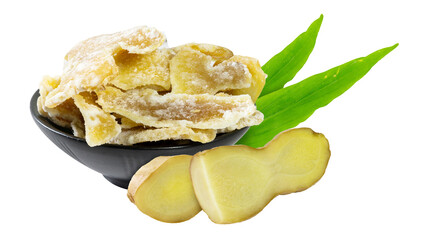 A black bowl piled with glossy ginger candy, accented by ginger slices and leaves on white.