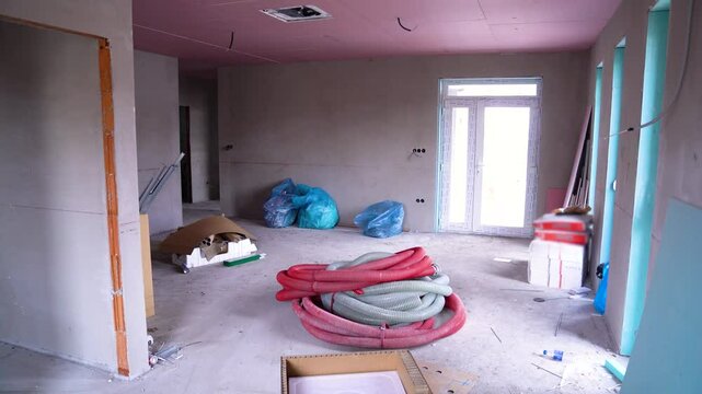 Unfinished interior room with construction supplies and open access to outside light