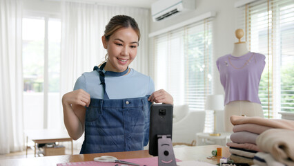 Asia people go green woman selfie live video vlog talk online teach make craft DIY eco second hand idea reuse old used fabric net zero waste fast fashion issue. Asian design hobby thrift retail store.