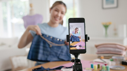 Asia people go green woman selfie live video vlog talk online teach make craft DIY eco second hand idea reuse old used fabric net zero waste fast fashion issue. Asian design hobby thrift retail store. © ChayTee